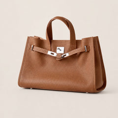 Brown leather tote bag from THE WHITMORE FAMILY's The Meridian collection, featuring sleek design and sturdy handles.