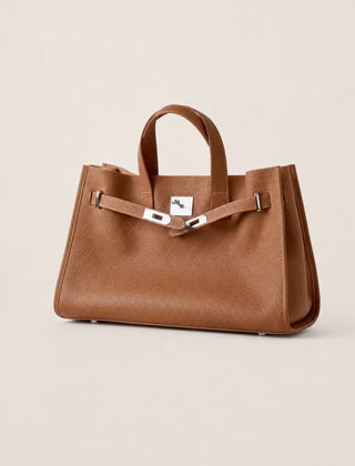 Brown leather tote bag from THE WHITMORE FAMILY's The Meridian collection, featuring sleek design and sturdy handles.