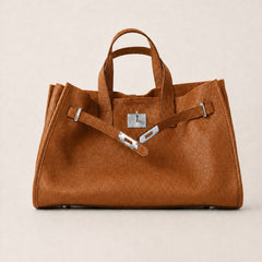 Brown leather tote bag from THE WHITMORE FAMILY's Meridian collection, featuring a stylish, spacious design and sturdy handles.