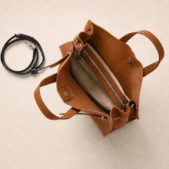 Interior view of THE WHITMORE FAMILY Meridian Leather Tote showing brown leather lining and spacious main compartment.