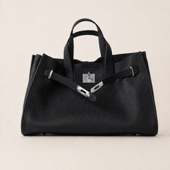 Black leather tote bag from THE WHITMORE FAMILY's Meridian collection, featuring a sleek and spacious design.