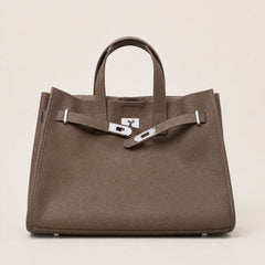 Coffee brown leather tote bag by THE WHITMORE FAMILY featuring sturdy handles and spacious interior for everyday use.
