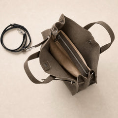 Coffee brown leather tote bag with interior compartments, featuring the Meridian Leather Tote by THE WHITMORE FAMILY.