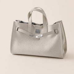 Cream leather tote bag with structured handles and spacious interior, designed by THE WHITMORE FAMILY.