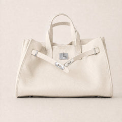 Cream leather tote bag from THE WHITMORE FAMILY's Meridian collection, featuring a spacious design and elegant craftsmanship.