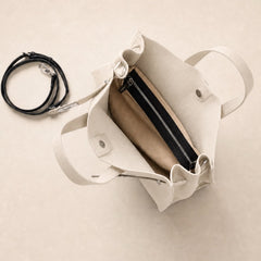 Cream leather tote bag with a spacious interior and multiple compartments, designed by THE WHITMORE FAMILY.