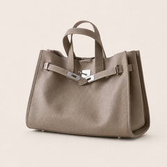 Taupe leather tote bag from THE WHITMORE FAMILY's Meridian collection, featuring sleek design and sturdy handles.