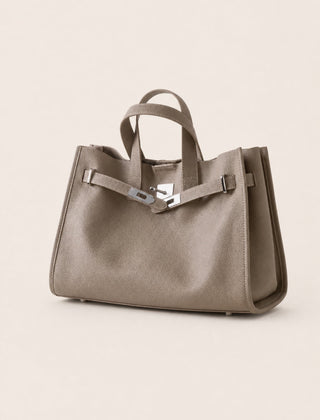 Taupe leather tote bag from THE WHITMORE FAMILY's Meridian collection, featuring sleek design and sturdy handles.