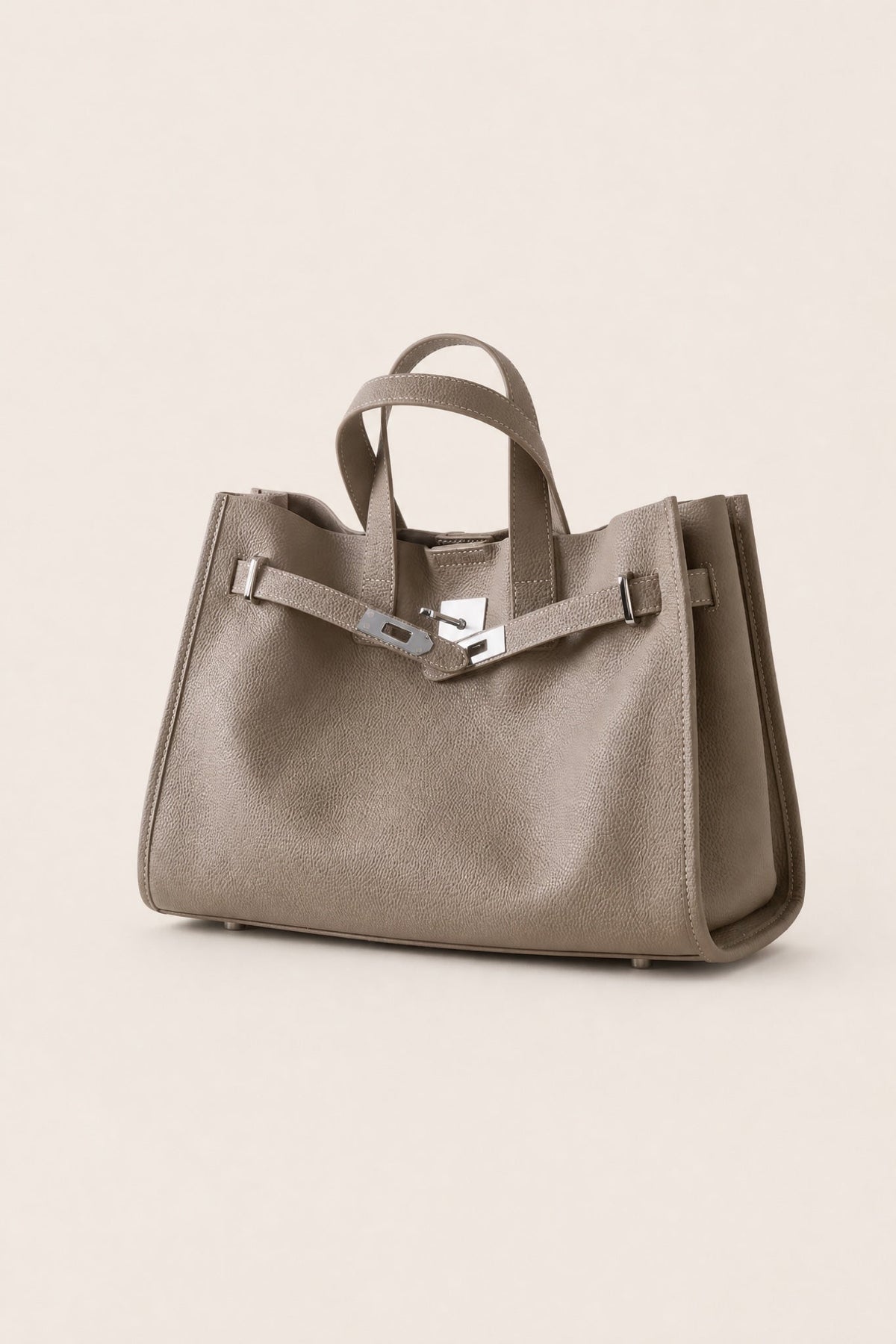 Taupe leather tote bag from THE WHITMORE FAMILY's Meridian collection, featuring sleek design and sturdy handles.
