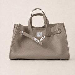 Taupe leather tote bag from THE WHITMORE FAMILY's Meridian collection, featuring sleek design and spacious interior.