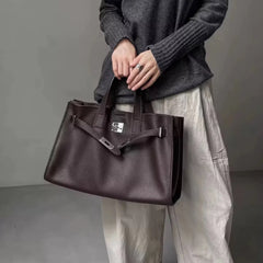 Margot Burgundy leather tote bag by THE WHITMORE FAMILY shown on model, featuring sleek design and spacious interior.