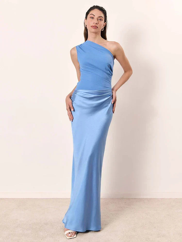 Ashley maxi dress by THE WHITMORE FAMILY in brown satin with a guilt detail, shown on a model.