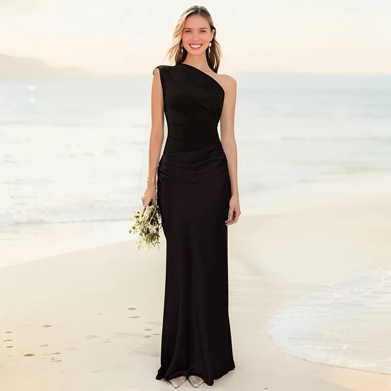 Ashley maxi dress in brown satin with a guilt detail from THE WHITMORE FAMILY, featuring a fitted bodice and flowing skirt.