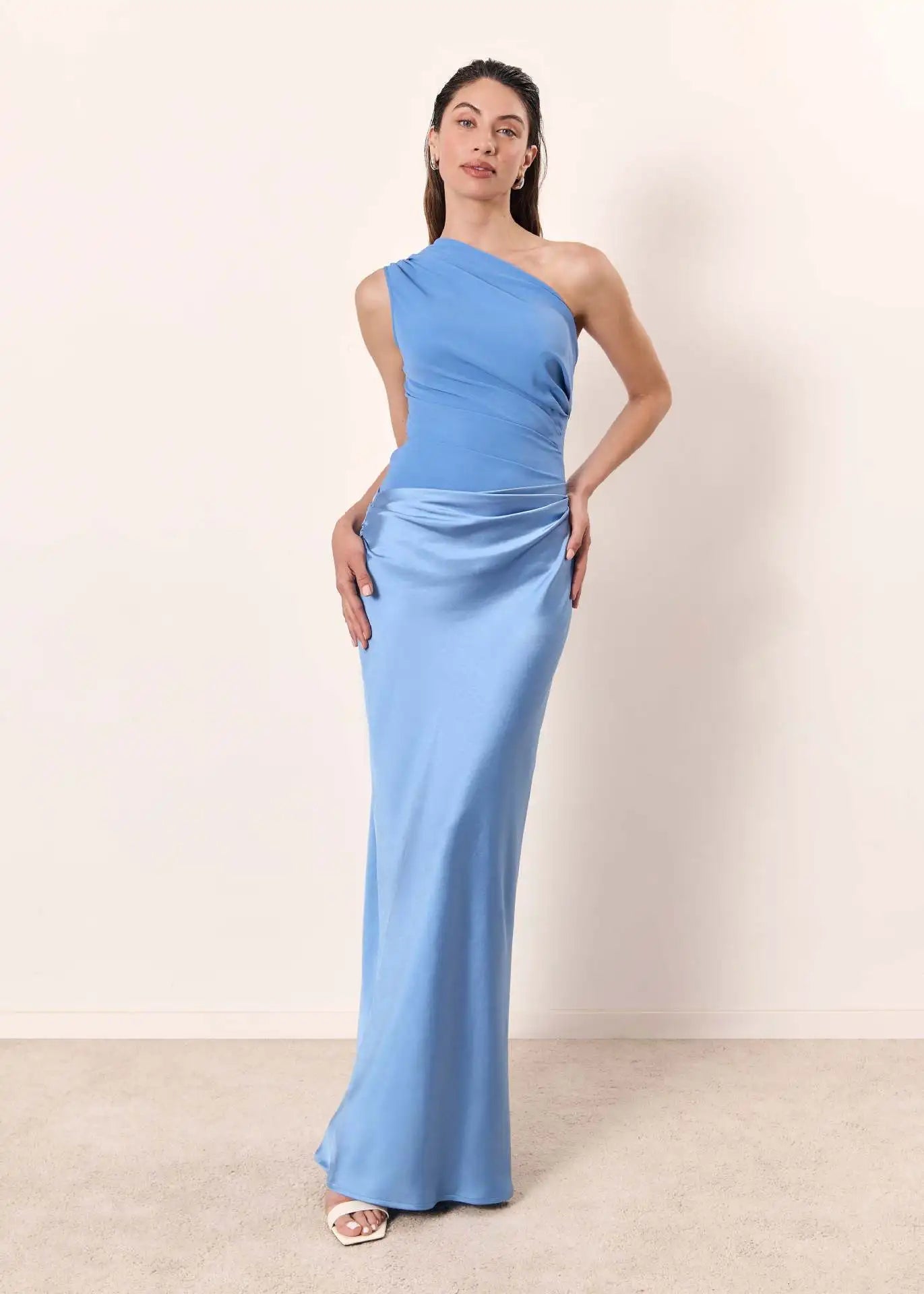 Ashley maxi dress by THE WHITMORE FAMILY in brown satin with a guilt detail, shown on a model.