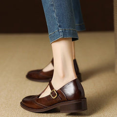 Beige Suzy Mary Janes by THE WHITMORE FAMILY, stylish slip-on shoes with rounded toes and decorative straps.