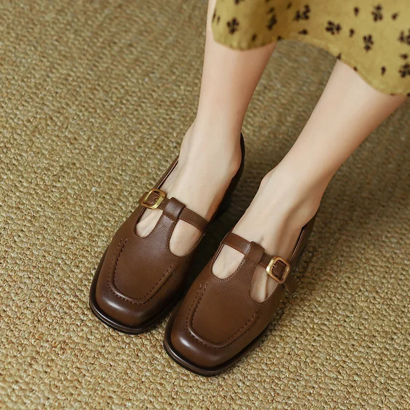 Black Ysolenne Classic Stylish T-Strap Pumps by THE WHITMORE FAMILY, featuring a sleek design and T-strap detail.