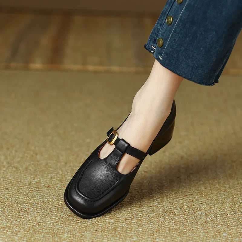 Black Ysolenne T-strap pumps by THE WHITMORE FAMILY, stylish classic footwear with sleek design and comfortable fit.