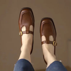 Black Ysolenne Classic Stylish T-Strap Pumps by THE WHITMORE FAMILY with sleek design and comfortable fit.