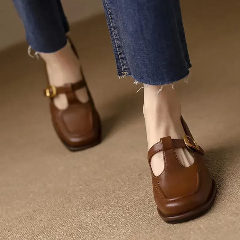 Black Ysolenne Classic Stylish T-Strap Pumps by THE WHITMORE FAMILY, showcasing elegant design and comfortable fit.