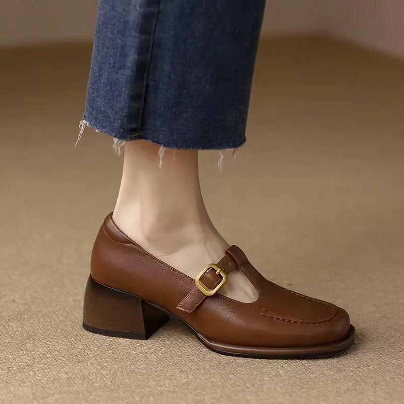 Black Ysolenne Classic Stylish T-Strap Pumps by THE WHITMORE FAMILY, featuring a sleek design and comfortable heel.