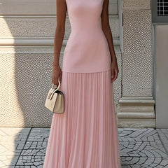 Cream Serena pleated maxi dress by THE WHITMORE FAMILY, flowing fabric with elegant pleats and a fitted bodice.