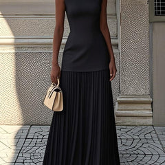 Cream Serena pleated maxi dress by THE WHITMORE FAMILY, flowing fabric with elegant pleats and a fitted bodice.