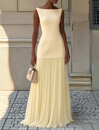 Cream Serena pleated maxi dress by THE WHITMORE FAMILY, flowing fabric with elegant pleats, full-length gown on a model.