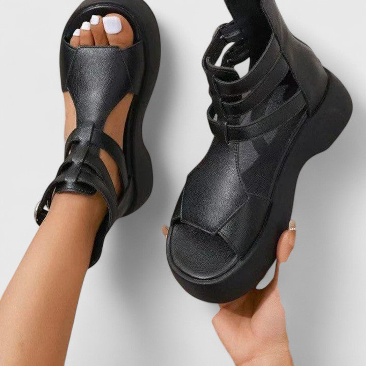 Black Ivana™ orthopedic sandals for women by THE WHITMORE FAMILY, featuring comfortable straps and supportive sole design.