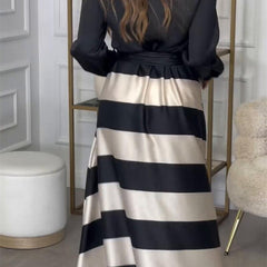 Burgundy Diana striped maxi dress by THE WHITMORE FAMILY, featuring a flowing design and long sleeves for a stylish look.