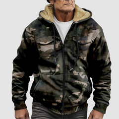 Sam™ camouflage jacket by THE WHITMORE FAMILY, shown in a close-up of the jacket's camouflage fabric and design details.