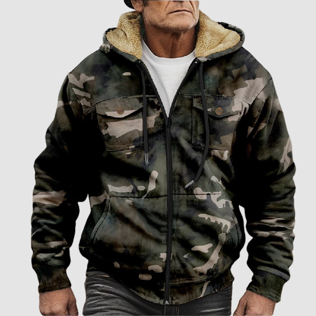 Sam™ camouflage jacket by THE WHITMORE FAMILY, shown in a close-up of the jacket's camouflage fabric and design details.