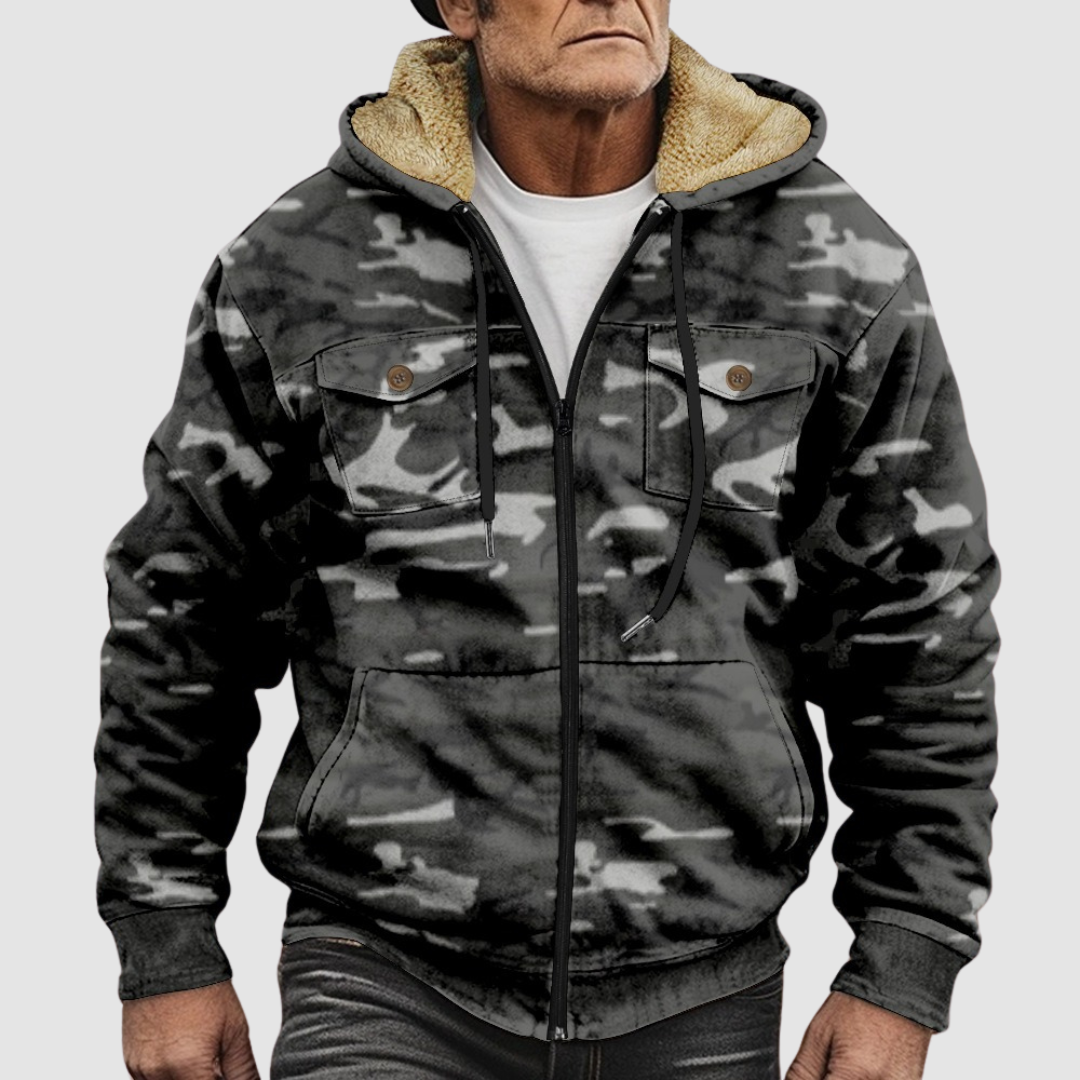 Sam™ camouflage jacket by THE WHITMORE FAMILY, shown with a front view, featuring green and brown camo pattern and zip closure.