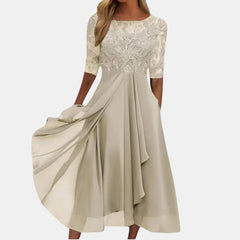 Blue Rhonda elegant lace dress by THE WHITMORE FAMILY, showcasing intricate lace details and a sophisticated fit.