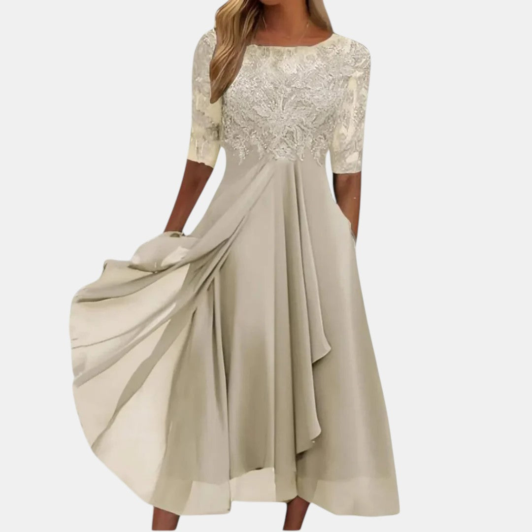 Blue Rhonda elegant lace dress by THE WHITMORE FAMILY, showcasing intricate lace details and a sophisticated fit.