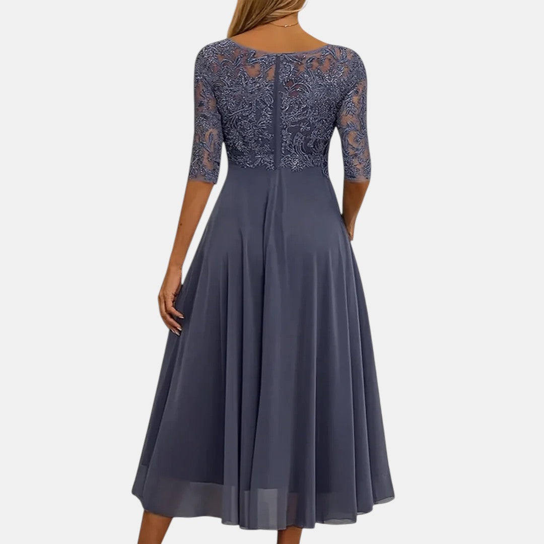 Blue elegant lace dress called Rhonda by THE WHITMORE FAMILY, featuring intricate lace details and a stylish fit.