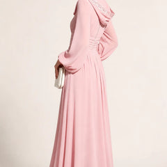 Blushing pink modest long sleeve wedding guest dress by THE WHITMORE FAMILY, elegant and suitable for special occasions.