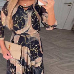 Brown Camille printed chiffon dress by THE WHITMORE FAMILY, flowing fabric with floral pattern and elegant design.