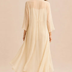 Elegant champagne dress featuring a refined camisole and chiffon jacket pant set by THE WHITMORE FAMILY, shown on a model.