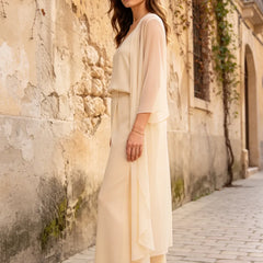 Elegant champagne dress by THE WHITMORE FAMILY featuring a refined camisole, chiffon jacket, and matching pants.