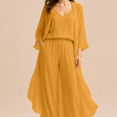 Elegant champagne dress by THE WHITMORE FAMILY featuring a refined camisole, chiffon jacket, and matching pants.