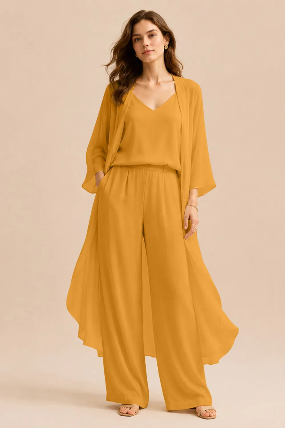 Elegant champagne dress by THE WHITMORE FAMILY featuring a refined camisole, chiffon jacket, and matching pants.