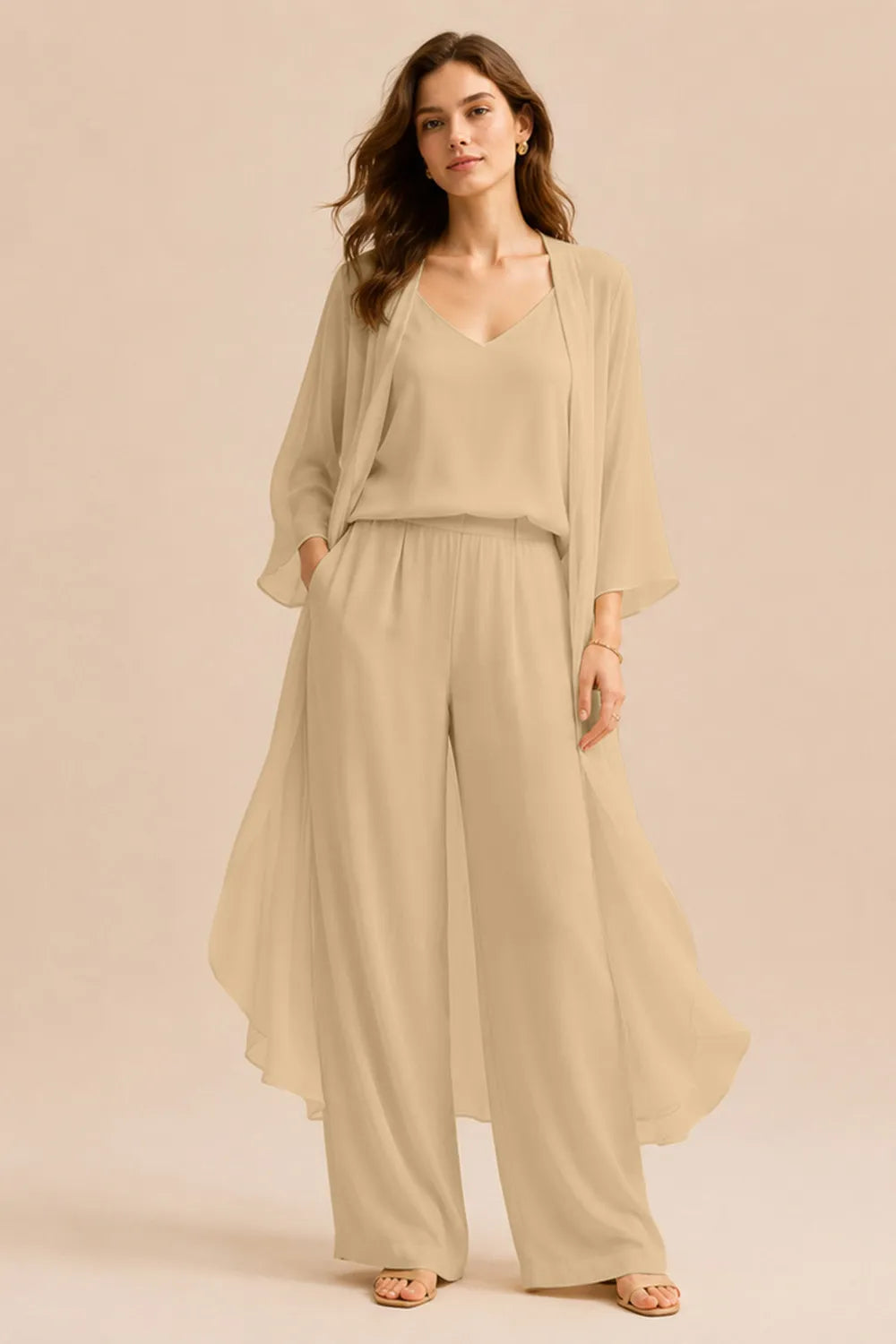 Elegant champagne dress by THE WHITMORE FAMILY featuring a refined camisole, chiffon jacket, and matching pants.