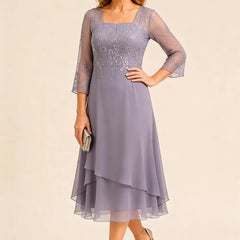 Embroidered chiffon mother of the bride dress by THE WHITMORE FAMILY, featuring elegant embroidery and a flowing silhouette.