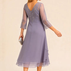 Embroidered chiffon mother of the bride dress by THE WHITMORE FAMILY, featuring elegant embroidery and flowing fabric.