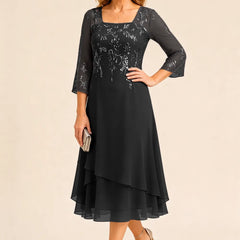 Embroidered chiffon Mother of the Bride dress by THE WHITMORE FAMILY, featuring elegant floral embroidery and a flowing silhouette.