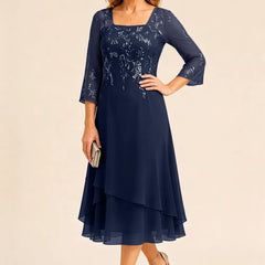 Embroidered chiffon mother of the bride dress by THE WHITMORE FAMILY, featuring intricate embroidery and elegant flowing fabric.