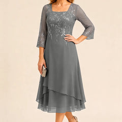 Embroidered chiffon mother of the bride dress by THE WHITMORE FAMILY, featuring elegant embroidery and a flowing silhouette.