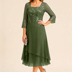 Embroidered chiffon mother of the bride dress by THE WHITMORE FAMILY with intricate embroidery and flowing fabric in a stylish design.