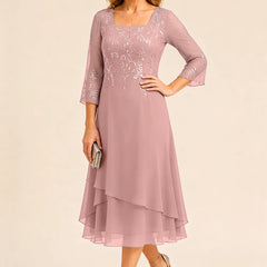 Embroidered chiffon mother of the bride dress by THE WHITMORE FAMILY, featuring elegant detailing and a flowing silhouette.