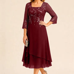 Embroidered chiffon Mother of the Bride dress by THE WHITMORE FAMILY, featuring elegant floral embroidery and flowing fabric.